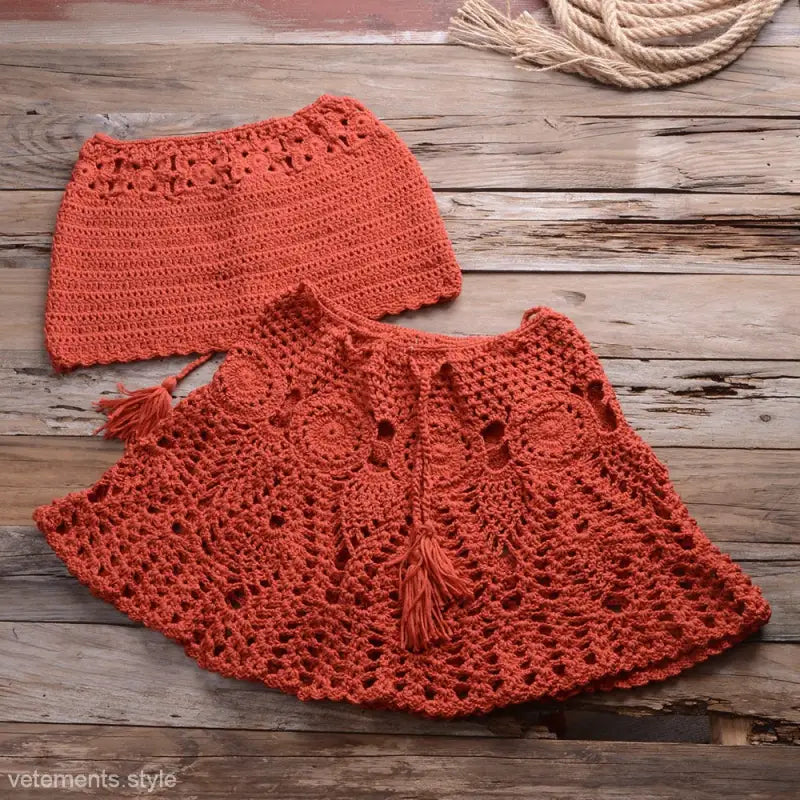 Crocheted coral poncho and skirt set with lace, featuring rusty red beach dress strap