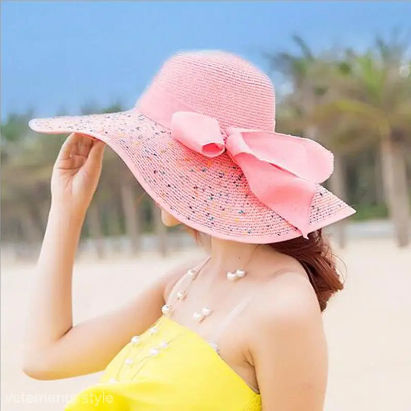 Pink wide-brimmed sun hat with decorative bow, perfect with Navy Blue Solid and Light Purple accents