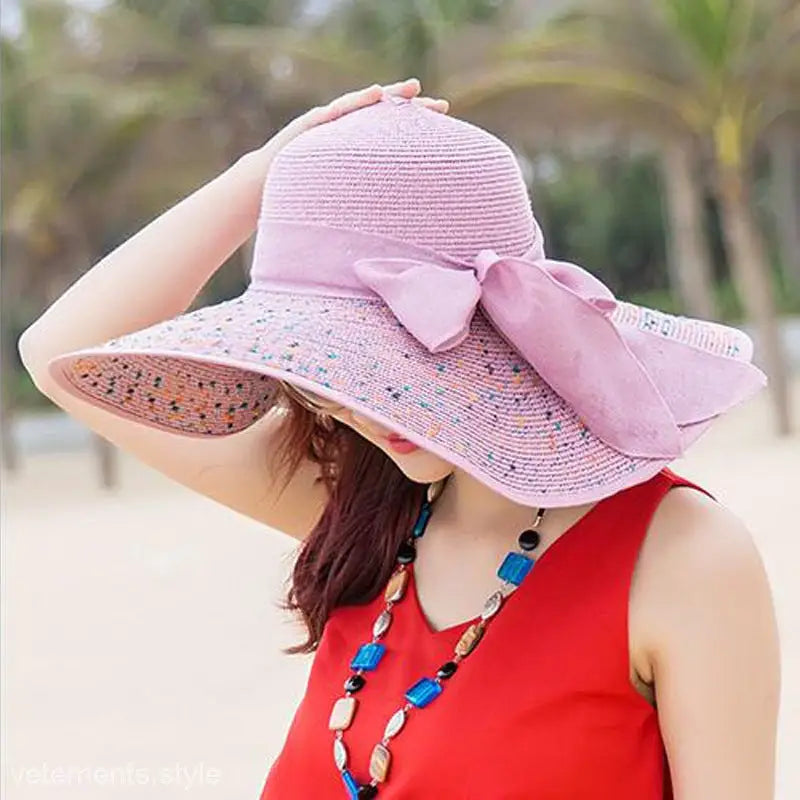 Pink wide-brimmed sun hat with decorative bow, ideal for navy blue solid or blue gypsophila accessories