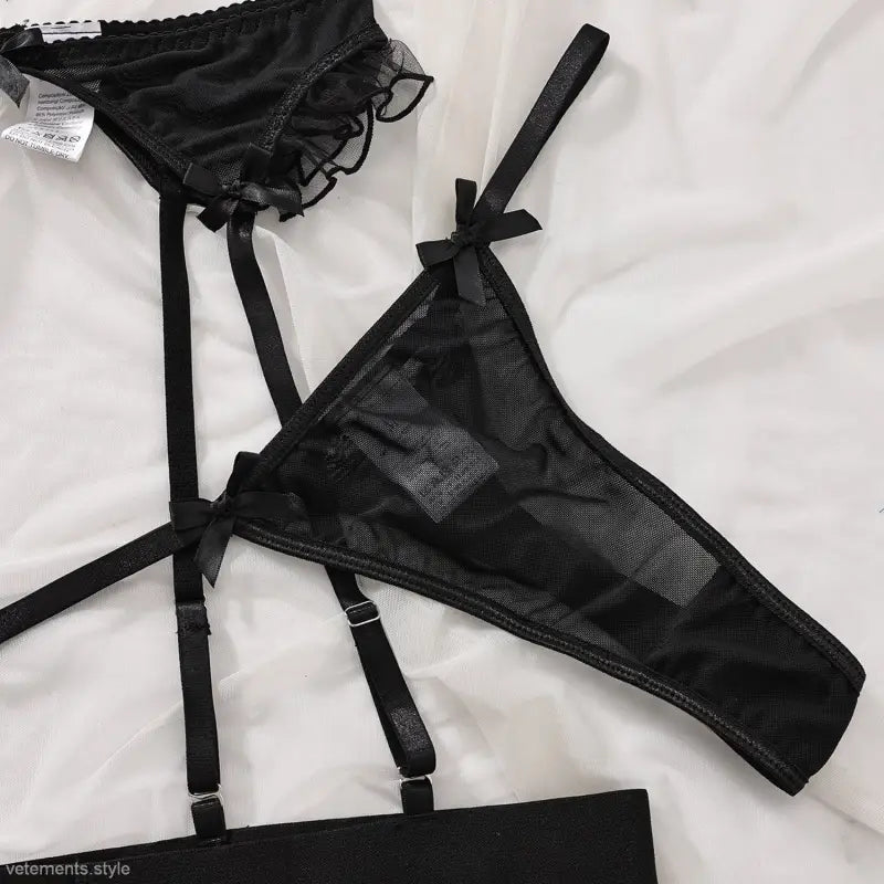 Black lingerie set featuring lace bow details, available with free shipping at Langry