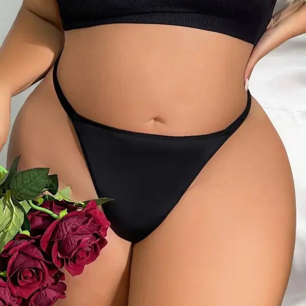 Woman’s torso in black underwear holding red roses showcasing Seasonless Nylon Ice Silk Panties