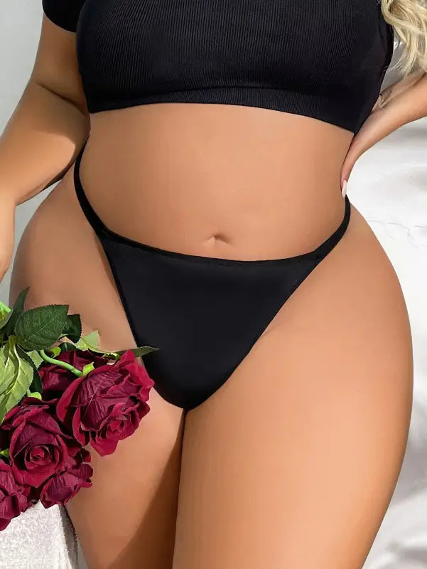 Woman’s torso in black underwear holding red roses showcasing Seasonless Nylon Ice Silk Panties