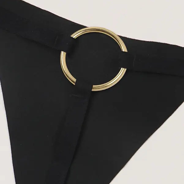 Black triangular fabric piece with gold circular clasp for seasonless nylon ice silk panties