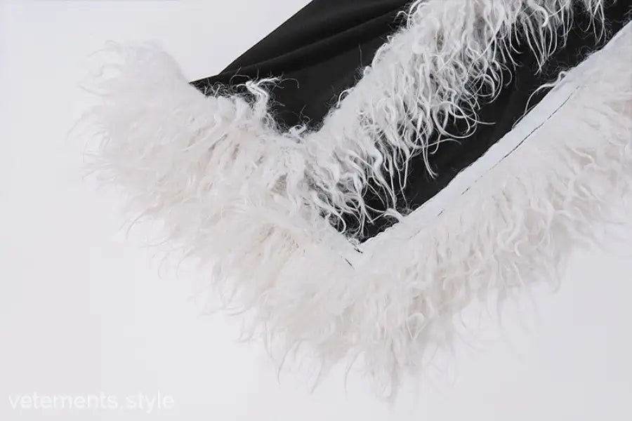 Elegant fluffy white feather against dark background on Maxi Dress with high grade fur stitching