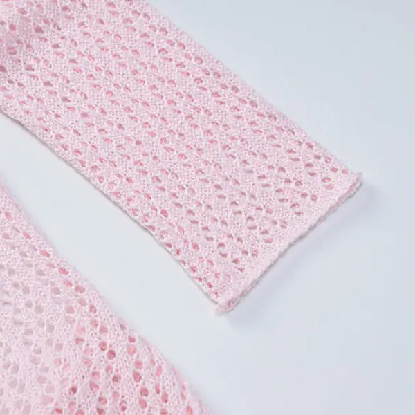 Pink crocheted garment sleeve detail from a backless knitted dress for parties