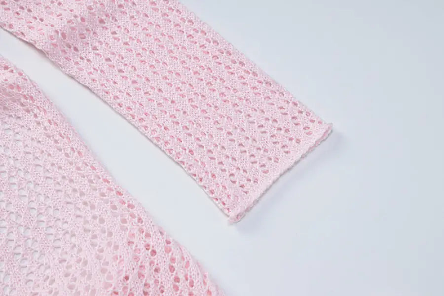 Pink crocheted garment sleeve detail from a backless knitted dress for parties
