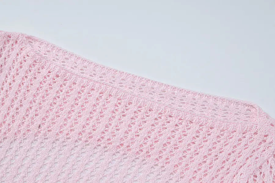 Pink crocheted fabric showcasing a backless knitted dress for parties and clubs