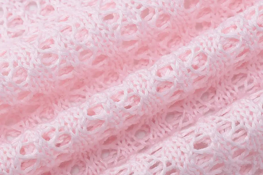 Pink open-knit fabric showcasing a sexy backless knitted dress for parties and clubs