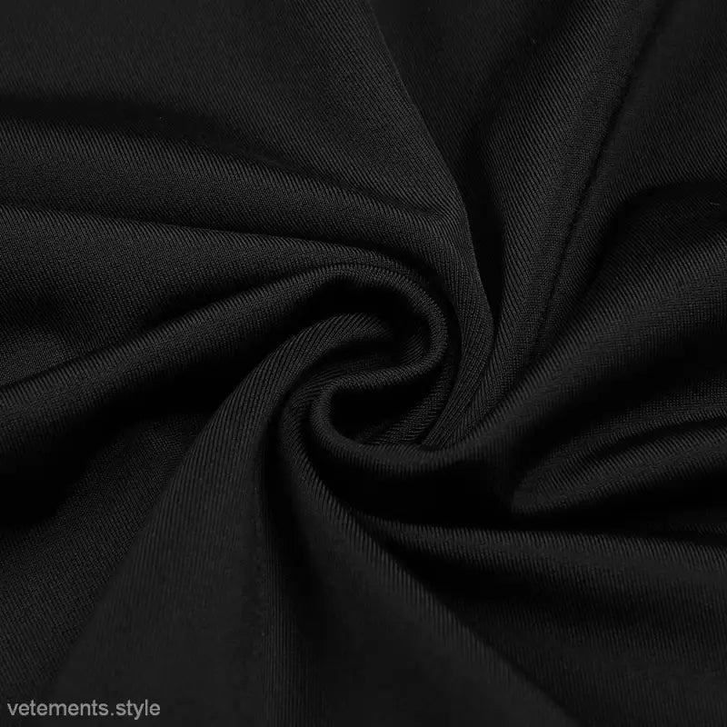 Swirled black textured fabric featuring folds on a backless maxi dress for parties