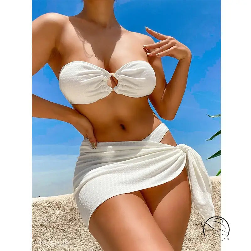 Tanned woman in sexy boho swimsuit beach bikini with white wrap skirt