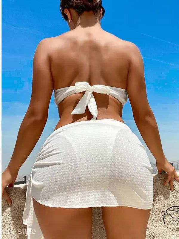 Woman in sexy boho swimsuit beach bikini against blue sky