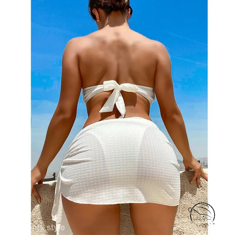 Woman in sexy boho swimsuit beach bikini against blue sky