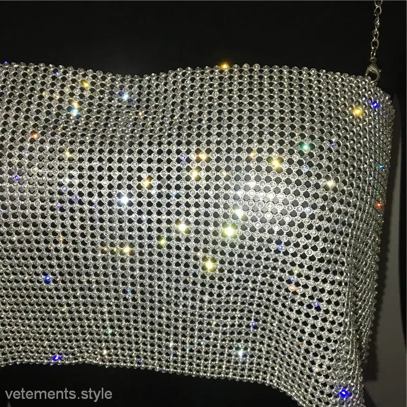 Glittering metallic mesh handbag with reflective elements complements the Chain Camisole Corset
