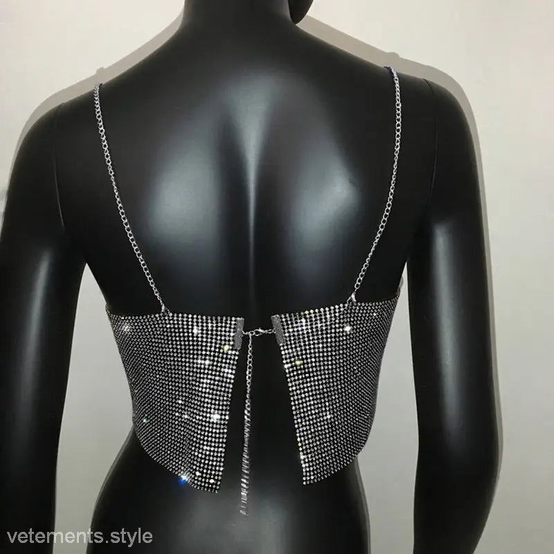 Glittery silver chain camisole corset with thin straps on black mannequin torso