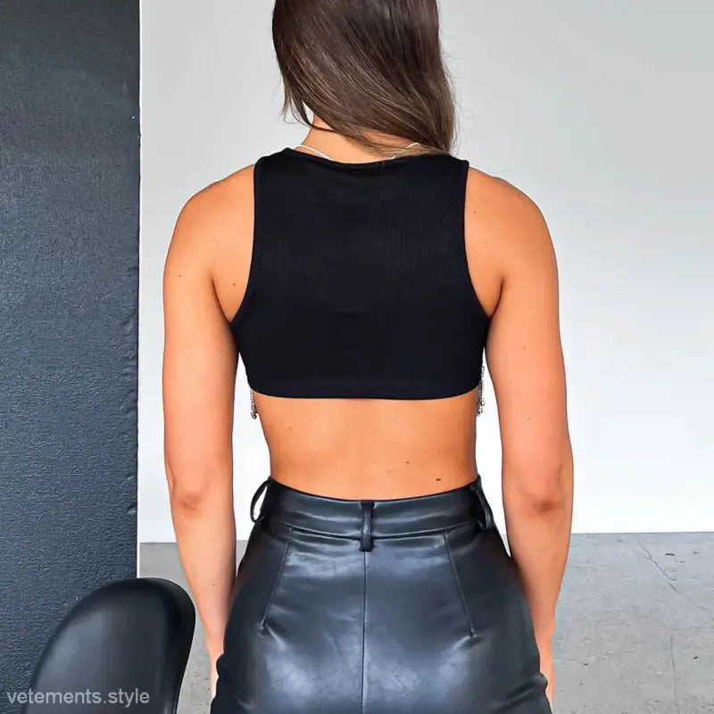 Woman wearing a black crop top and leather skirt, showcasing the sexy daily vest style