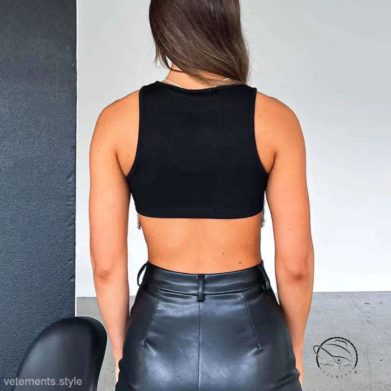 Woman in sexy daily vest crop top and leather skirt from behind