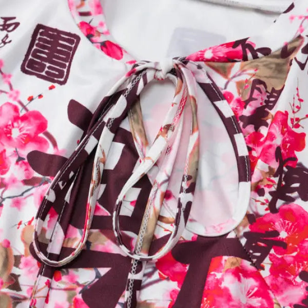 Floral-patterned fabric with Chinese characters and a tied ribbon detail.