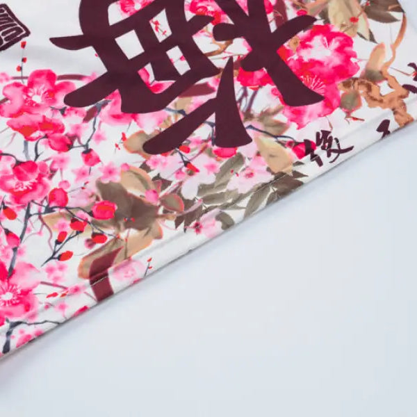 Decorative fabric or paper with cherry blossom design and Chinese characters.