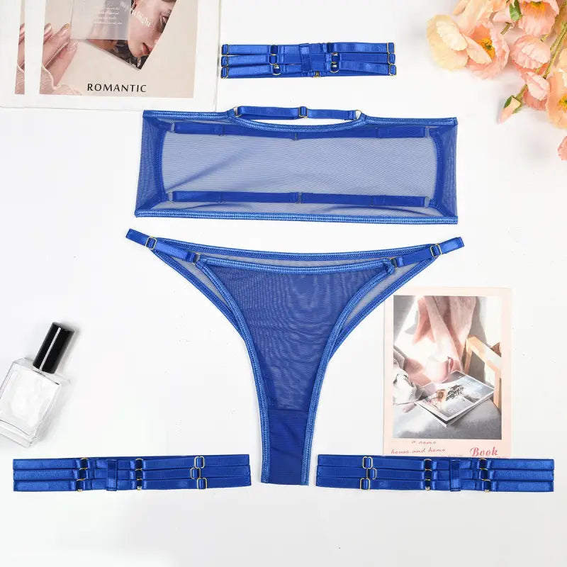 Blue mesh lingerie in a four piece set featuring bandeau top, thong, and garter belts