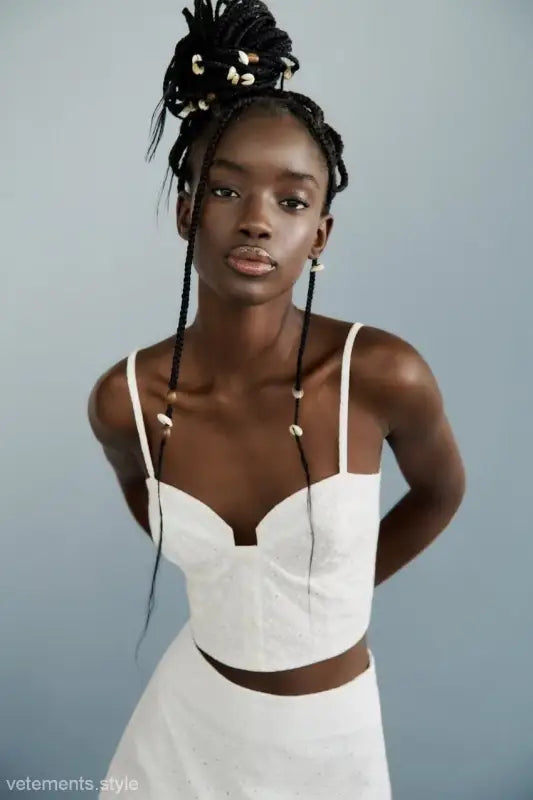 Woman in white crop top and skirt showcasing French Niche Hollow Cutout design