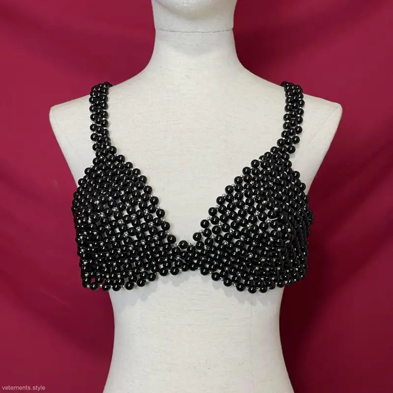 Black beaded bralette on mannequin showcasing handmade pearl bra for summer wear