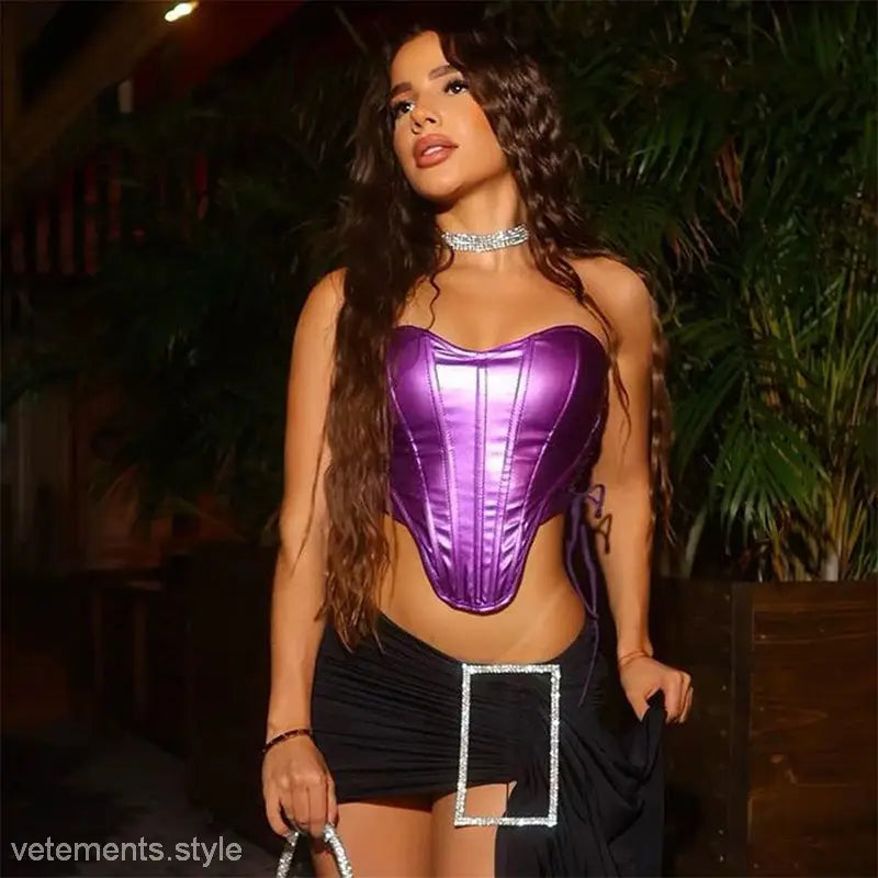 Woman modeling shiny purple corset top with black mini-skirt, perfect for lace crop top style
