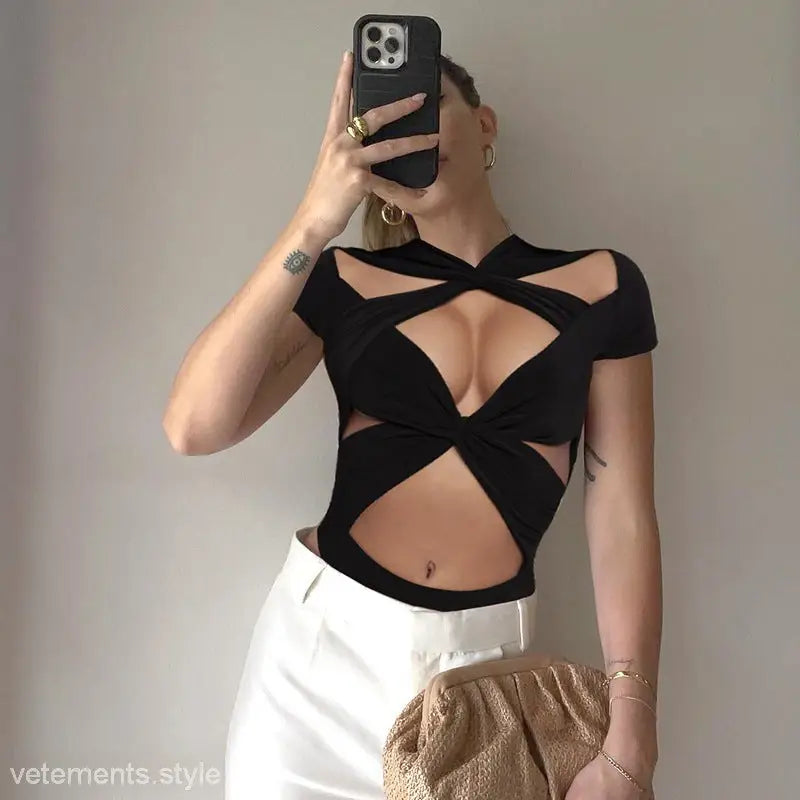Black cutout crop top showcasing geometric design, perfect for the Lace Cutout V-Neck Short Sleeve White Cross Jumpsuit