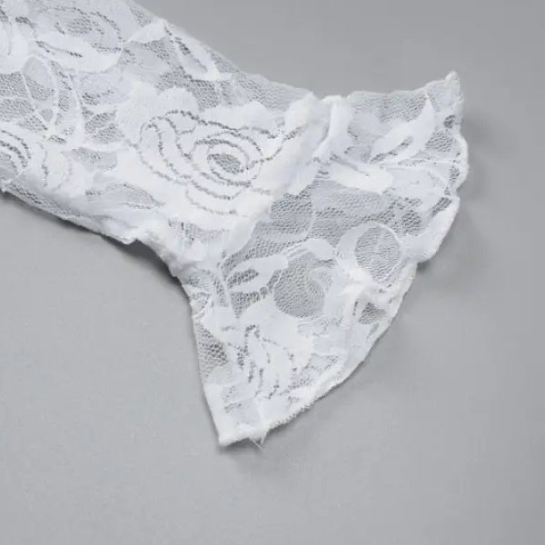 Delicate white lace fabric with a floral pattern.
