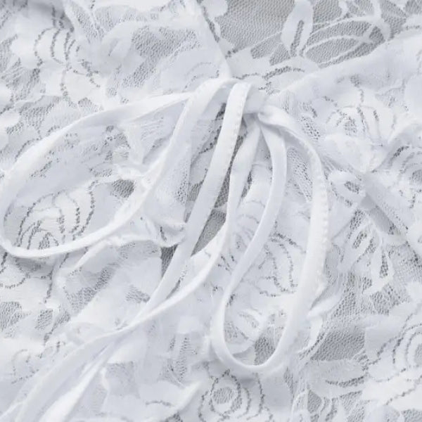 Delicate white lace fabric with a floral pattern and ribbon.