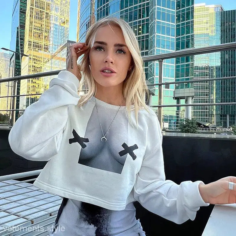 Blonde woman wearing a white long sleeve pullover with graphic design, stylish and sexy