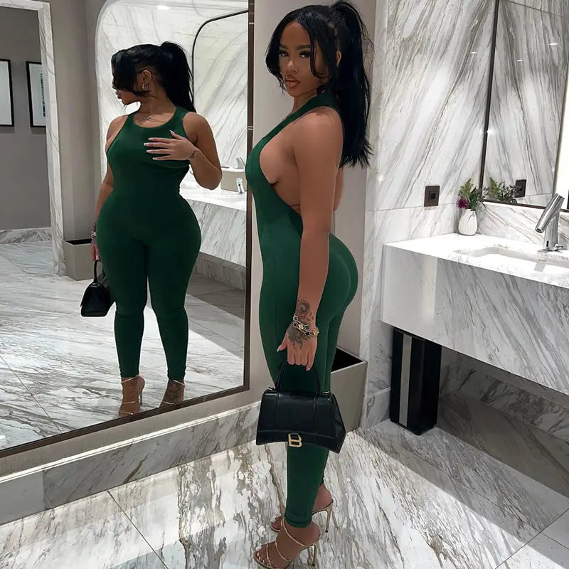 Woman in green buckle yoga jumpsuit featuring a stylish metal buckle design for summer wear