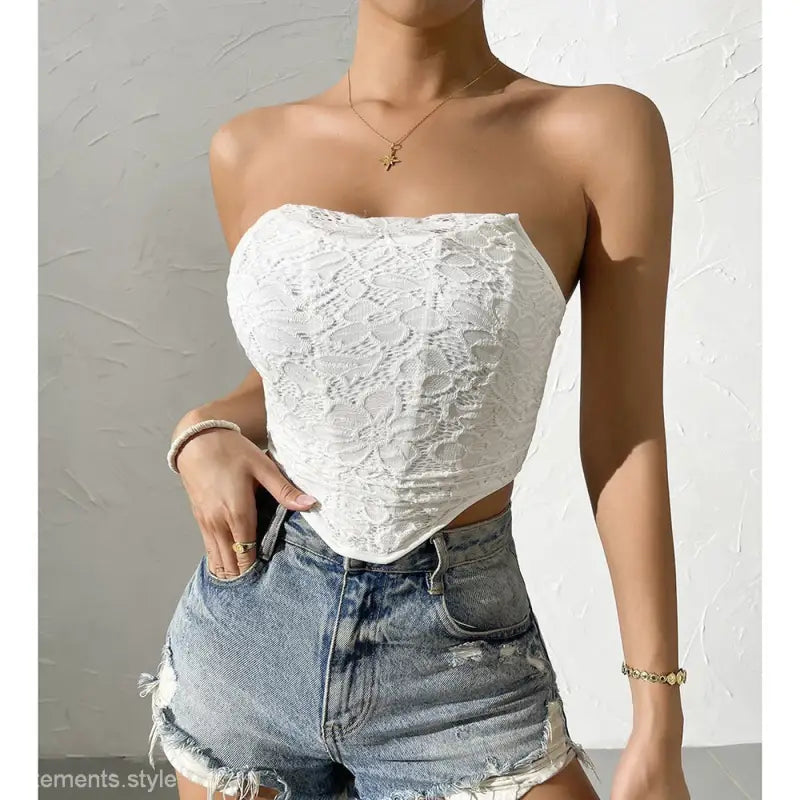 White lace bandeau top with pointed hem and distressed denim shorts, perfect as a sexy off-shoulder corset alternative