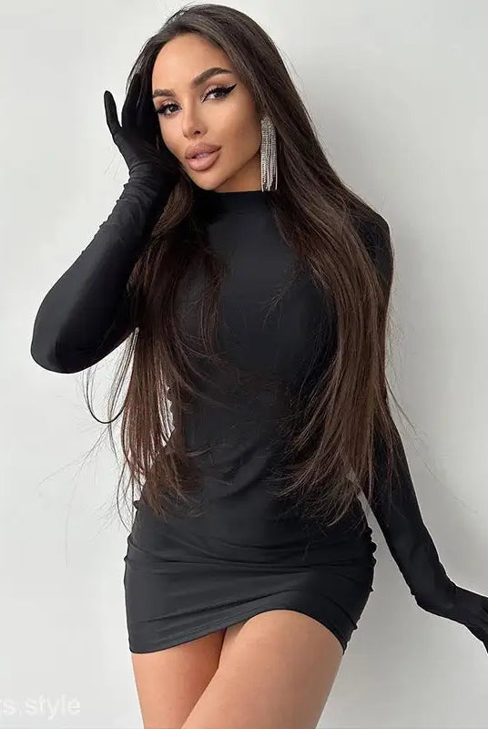 Woman in a sexy sheath long party bodycon dress and long sleeve gloves against white background