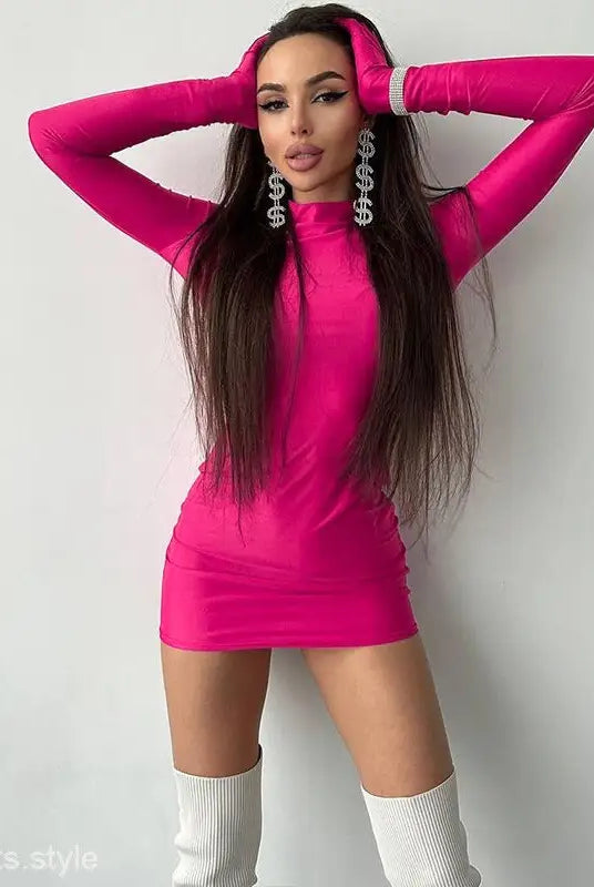 Woman in a hot pink sexy sheath long sleeve bodycon dress with white knee-high socks