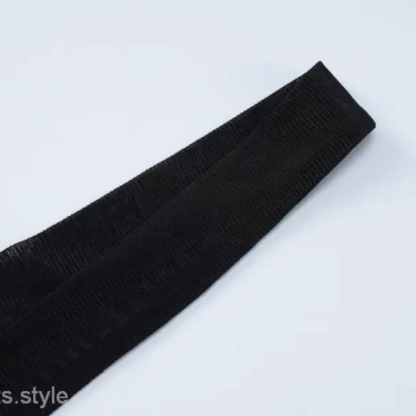 Black fabric strip with a curved shape on a sexy short mesh dress for summer parties