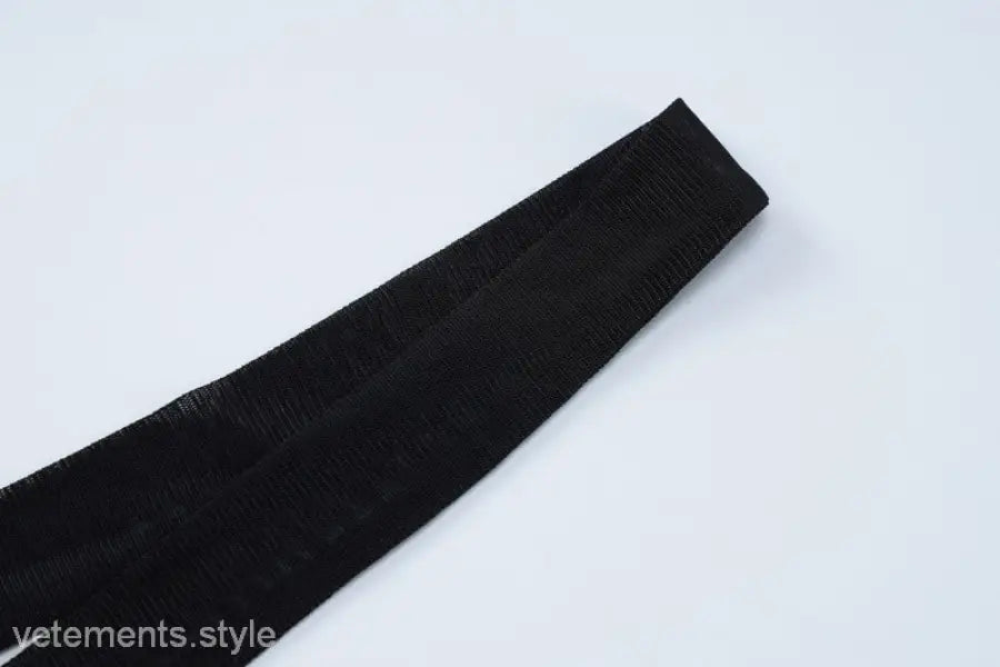 Black textured fabric with diagonal folds on a sexy short mesh dress for summer parties