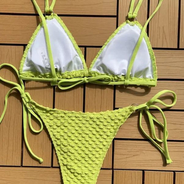Lime green and white string bikini swimsuit with textured bottoms.