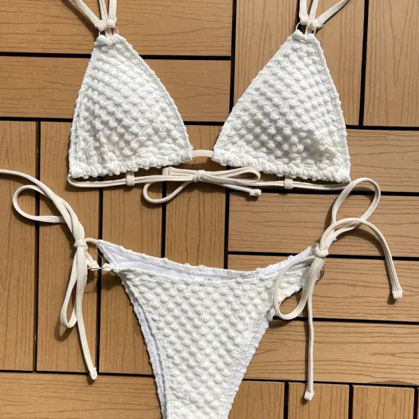 White textured bikini with triangle top and tie-side bottom.