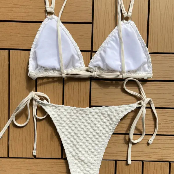 White string bikini with a triangle top and textured bottom.