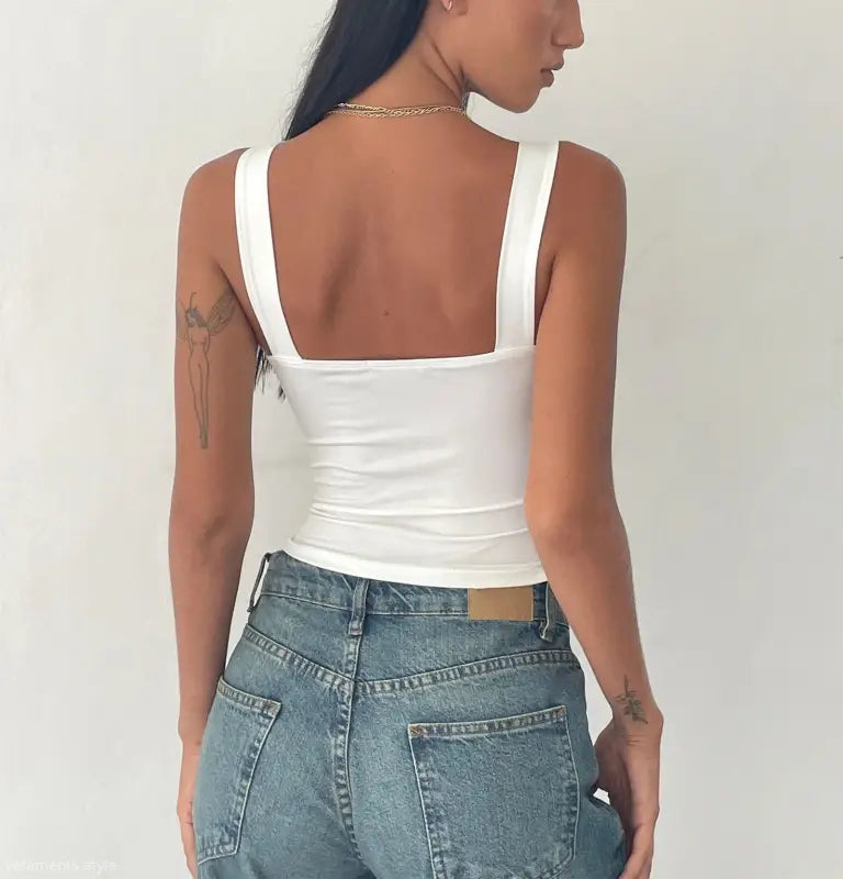 Fashionable slim cutout camisole top by Vetements Style worn with blue jeans