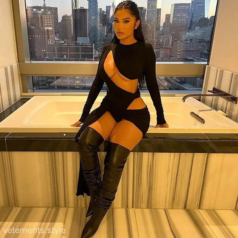 Woman in a sexy slim jumpsuit with cutout tie neck and thigh-high boots