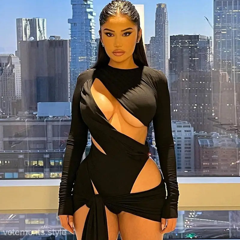 Woman in a sexy slim jumpsuit with cutouts, posing against a vibrant city skyline