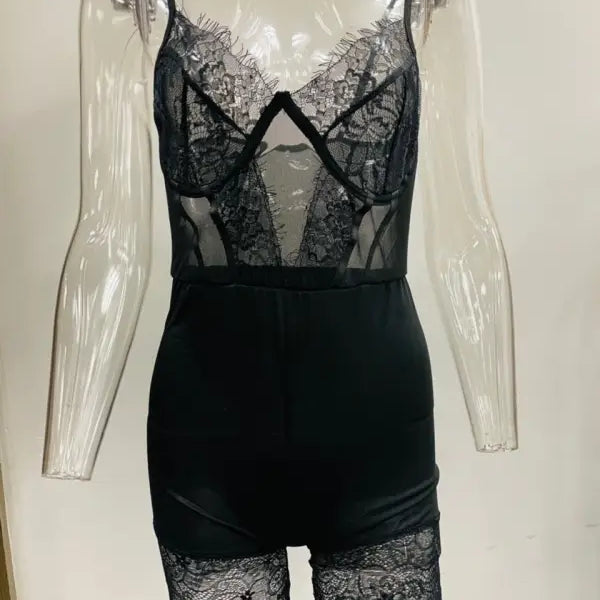 Black lace bodysuit with sheer panels and shorts-style bottom, a sexy strappy low-cut jumpsuit