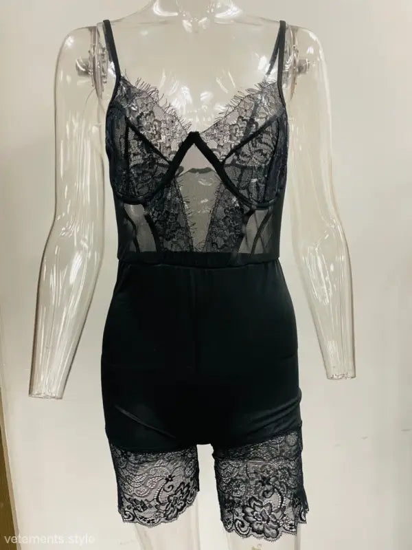Black lace bodysuit with sheer panels and shorts-style bottom, a sexy strappy low-cut jumpsuit