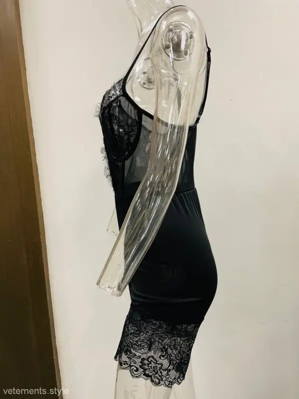 Black lace-trimmed bodycon dress on transparent mannequin, perfect for sexy strappy low-cut looks