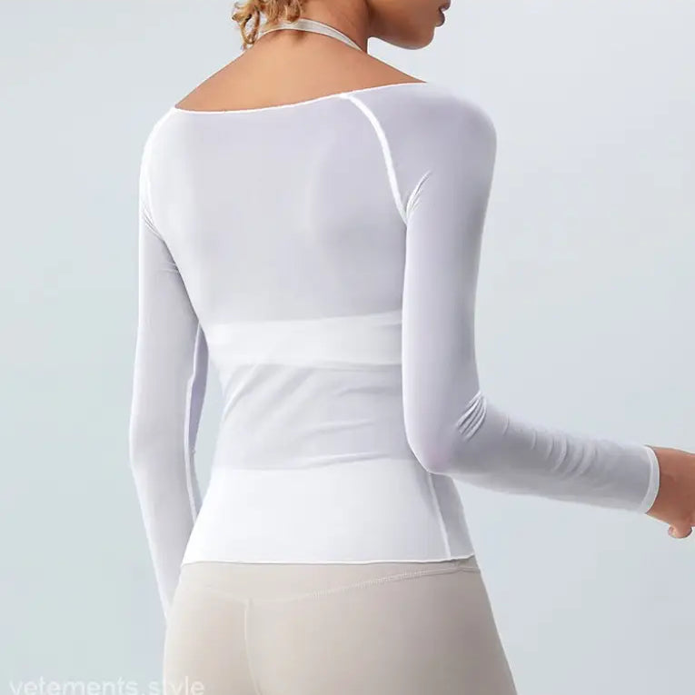 White long-sleeved fitted top with wide waistband showcasing sexy yoga blouse in coral red and light blue