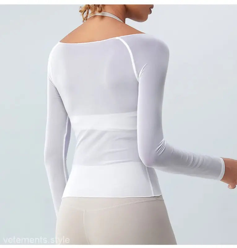 White long-sleeved fitted top with wide waistband showcasing sexy yoga blouse in coral red and light blue