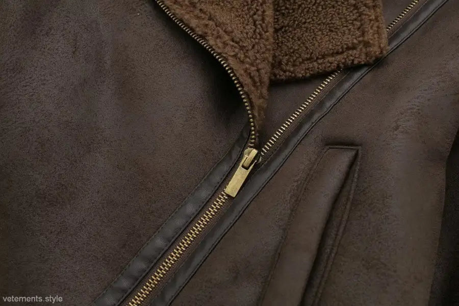 Brown leather jacket with fleece short stitching, gold zipper, and fleece collar