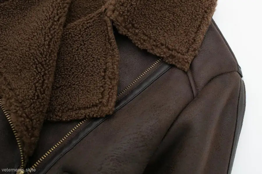 Brown leather shearling jacket with fleece short stitching, gold zipper, and fuzzy collar