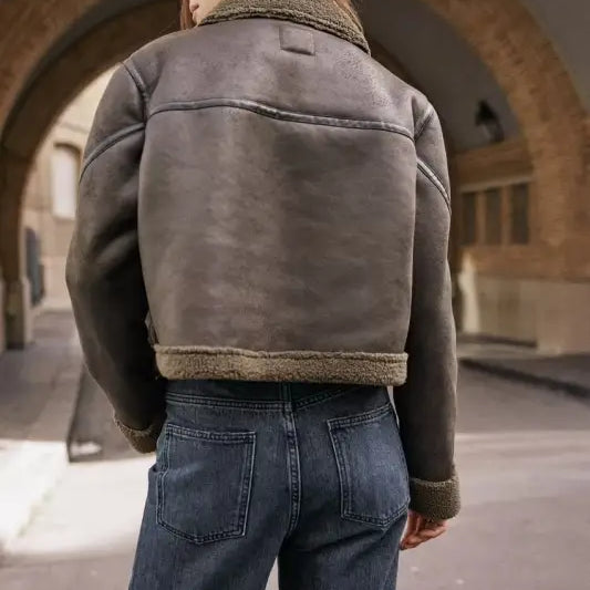 Shearling-lined leather jacket with fleece short stitching, paired with blue jeans